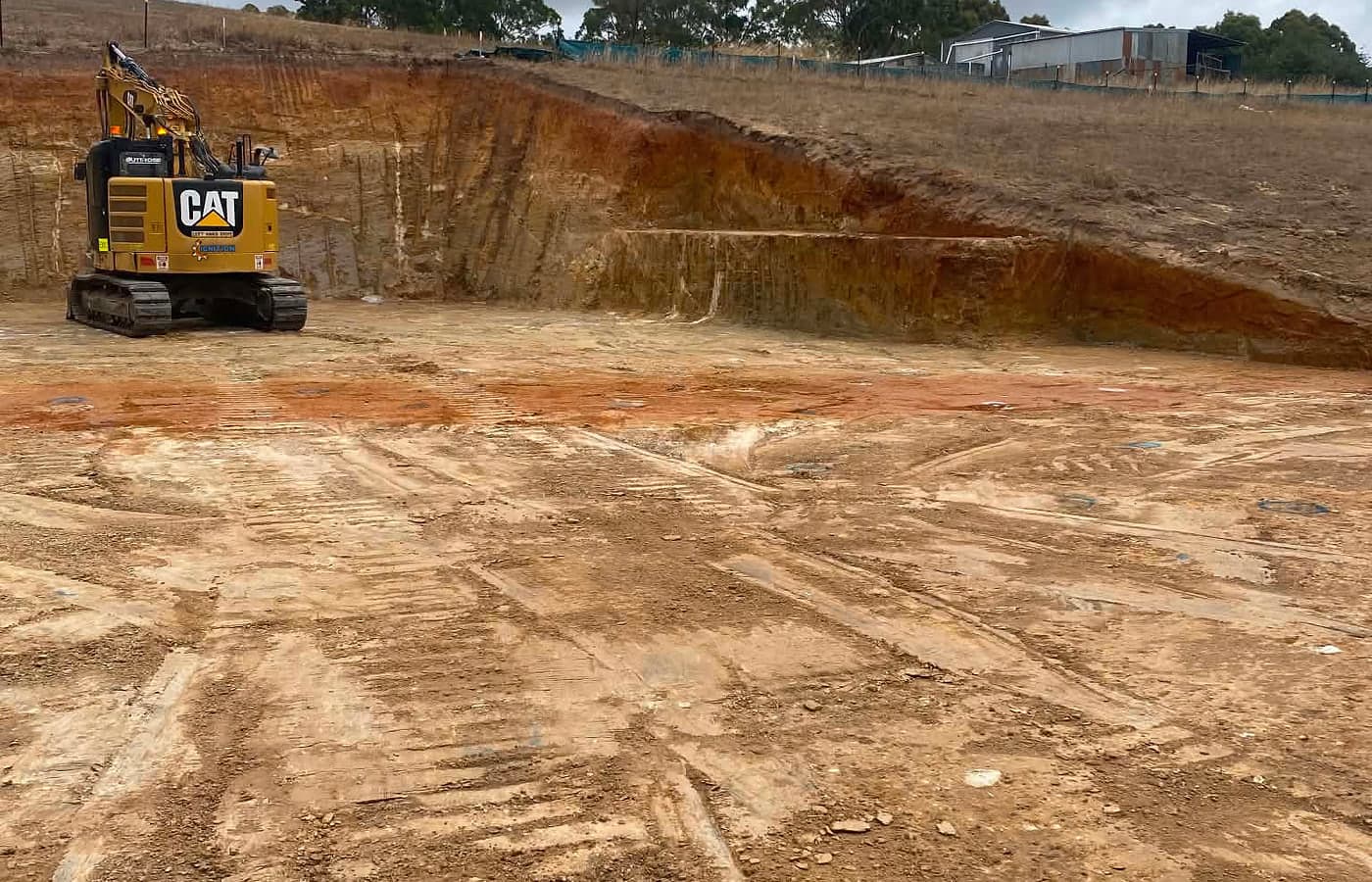 Excavator working on a cut site